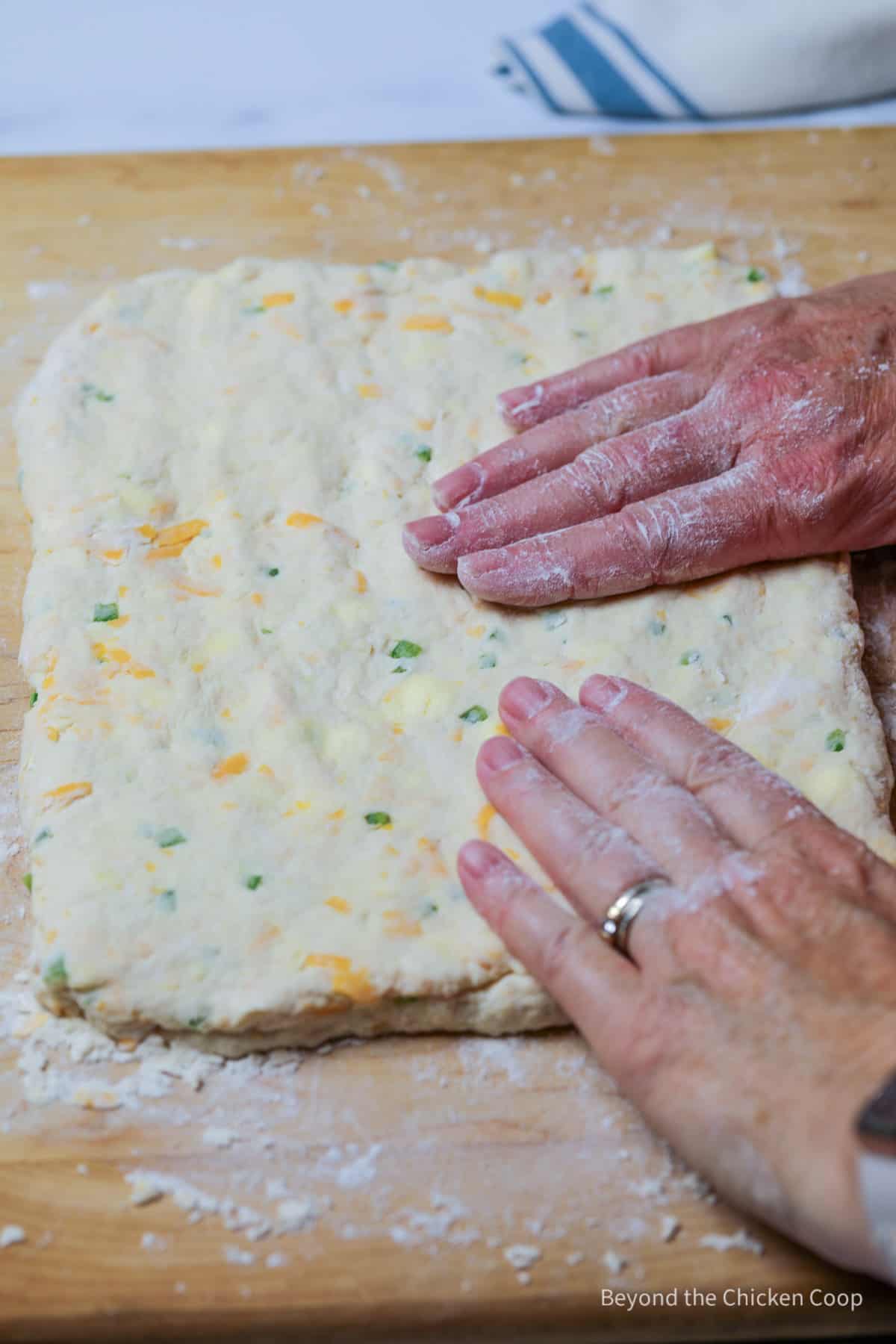 Forming biscuit dough into a rectangle.
