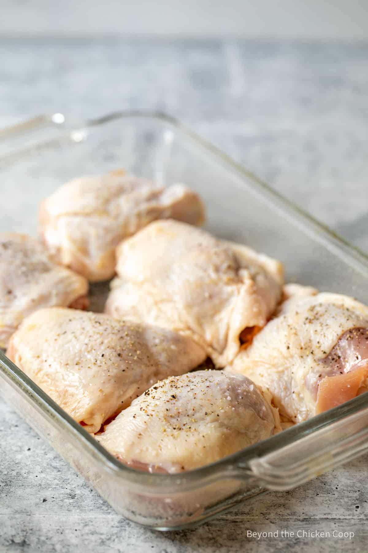 Chicken thighs in a casserole dish.