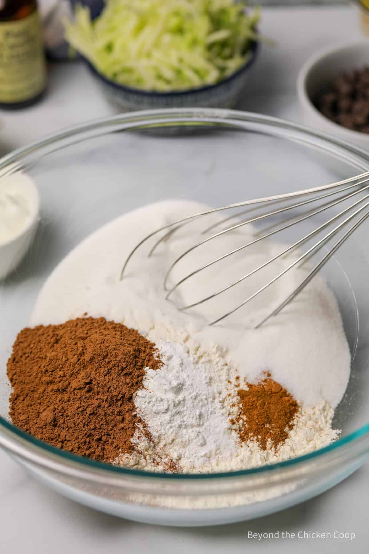 Mixing dry ingredients together with a whisk. 