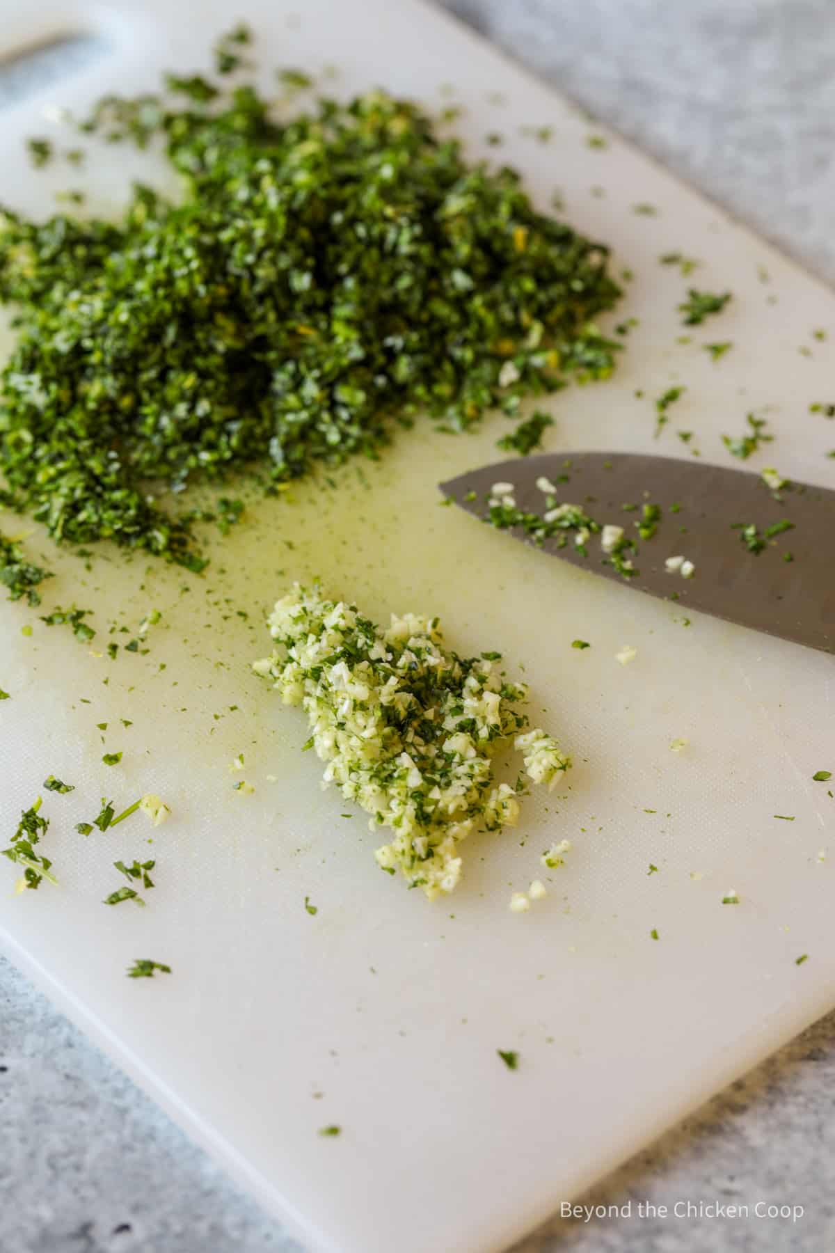 Finely chopped garlic on a cutting board.