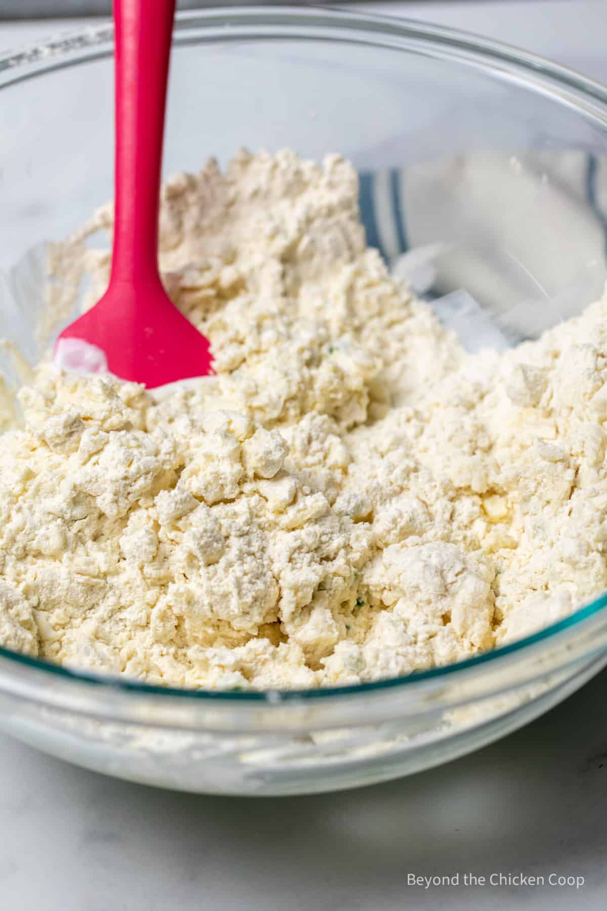 Mixing dough in a bowl with a spatula.