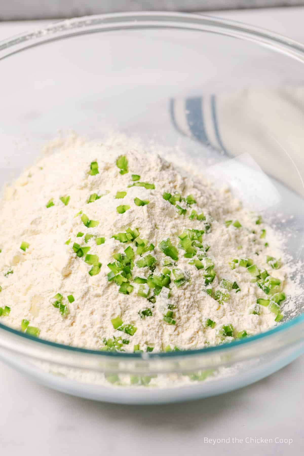 Diced jalapenos in a flour mixture.