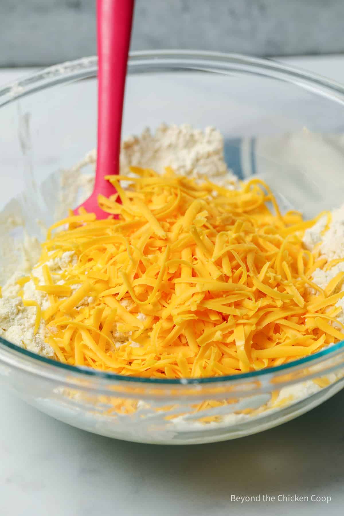 Shredded cheese in a large mixing bowl.