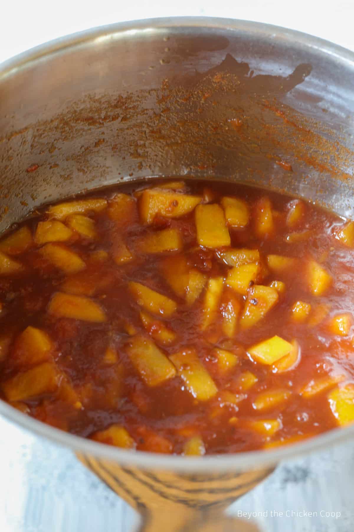 Cooking peach barbecue sauce in a pot. 