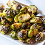 A plate filled with roasted brussels sprouts.