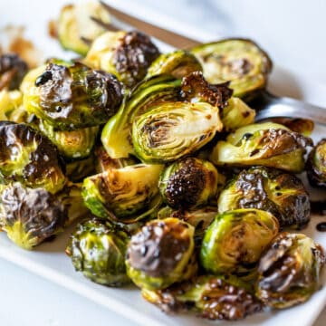 A plate filled with roasted brussels sprouts.