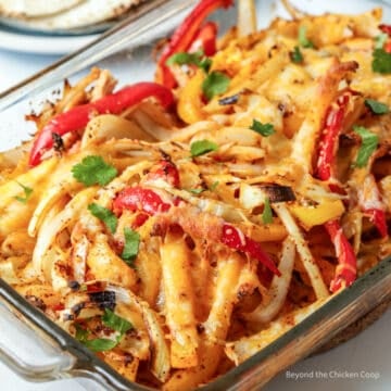 Strips of chicken, peppers and onions in a baked casserole.