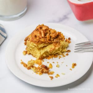 A slice of coffee cake on a small white plate.
