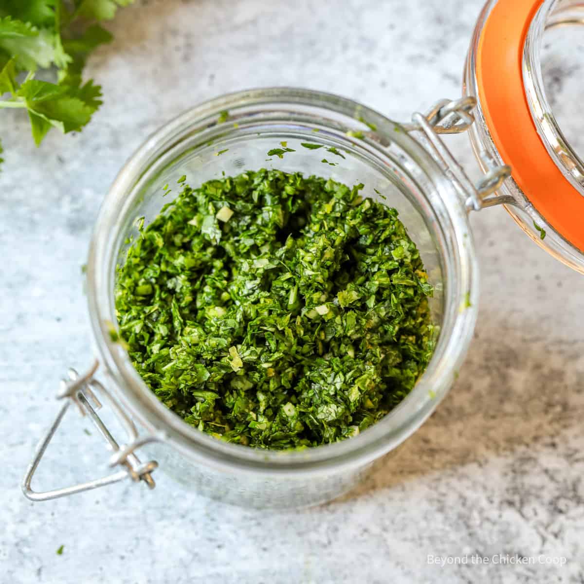 Chopped gremolata in a glass jar. 