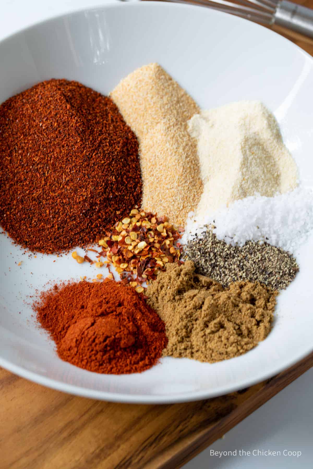 Spices measured into a white bowl.