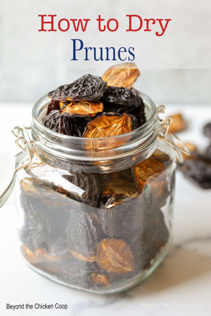 A glass filled with dried prunes.