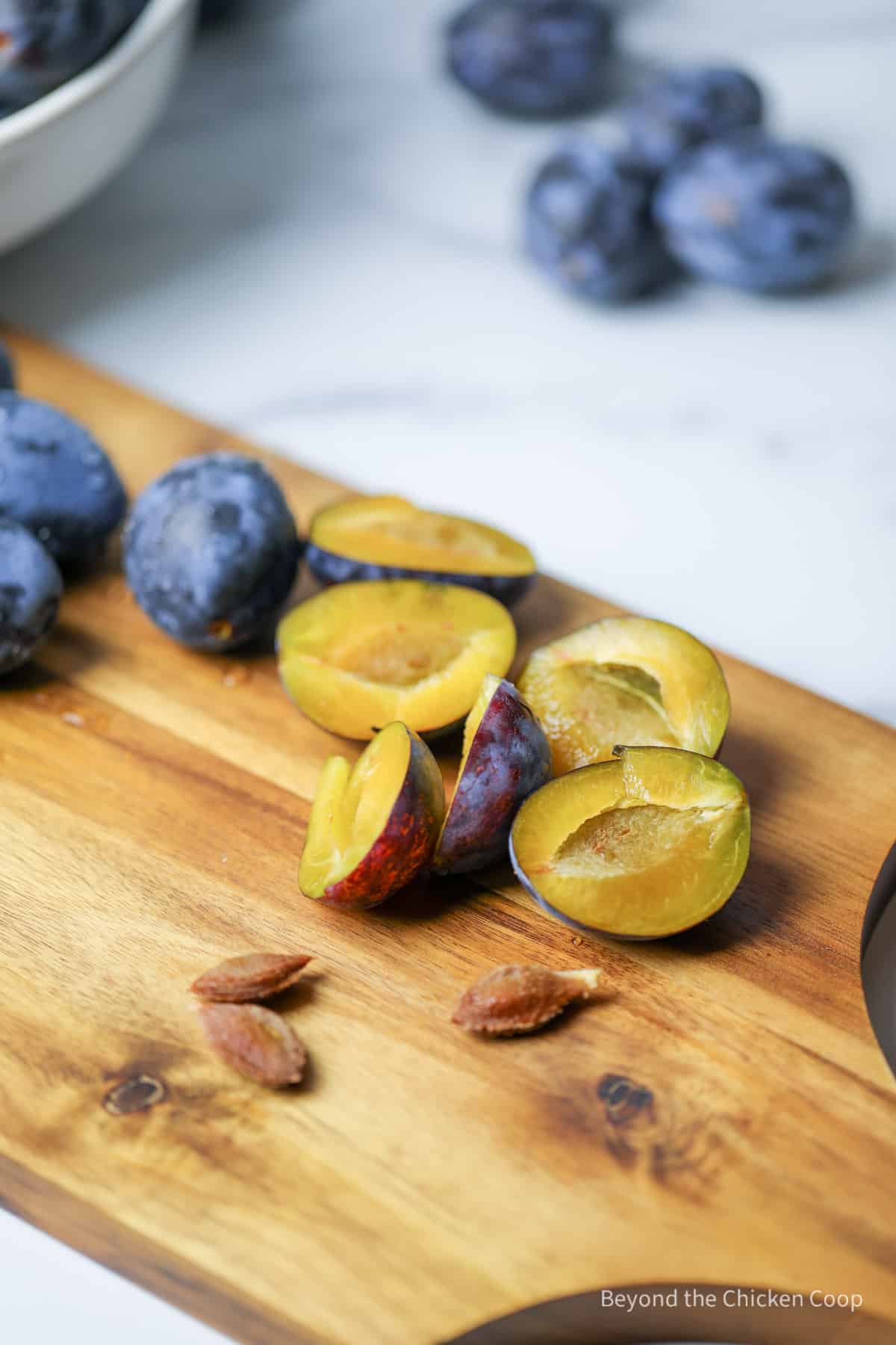 Slicing plums to remove the seeds. 