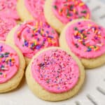Pink frosted Lofthouse Cookies topped with sprinkles.