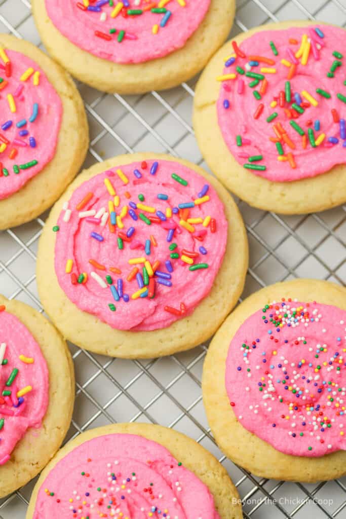 Lofthouse sugar cookies topped with pink frosting and sprinkles.