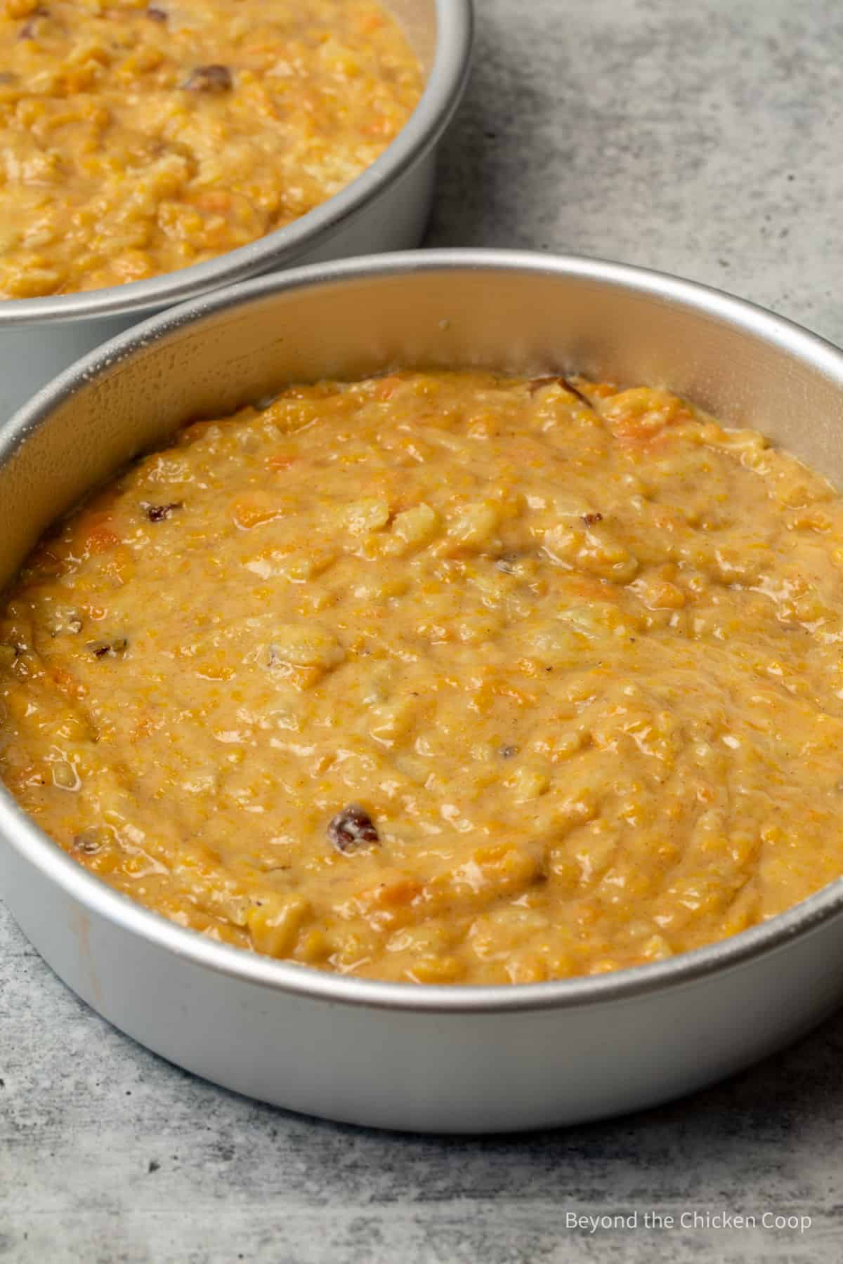 Carrot cake batter in round cake pans. 