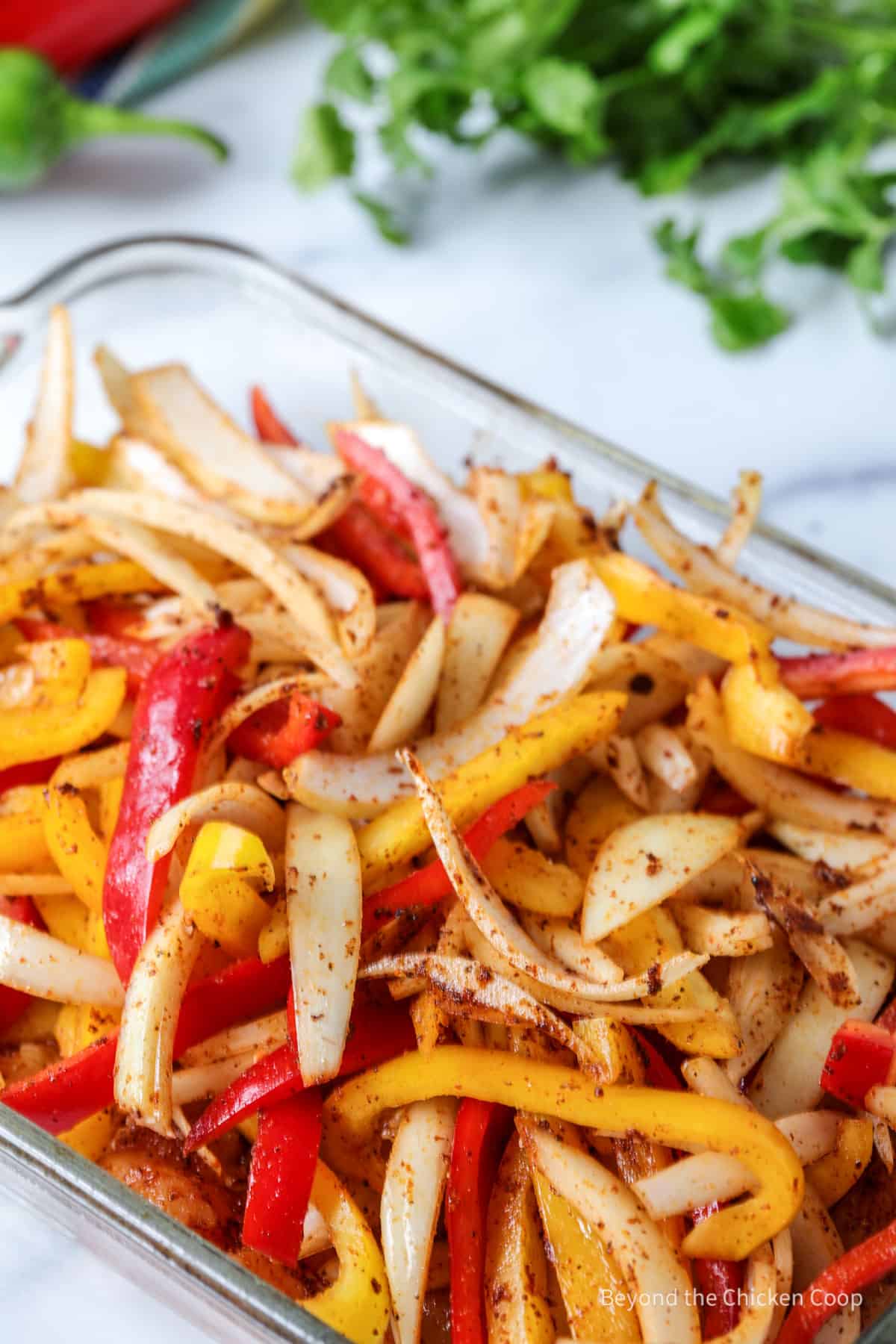 Peppers and onions in a casserole dish. 