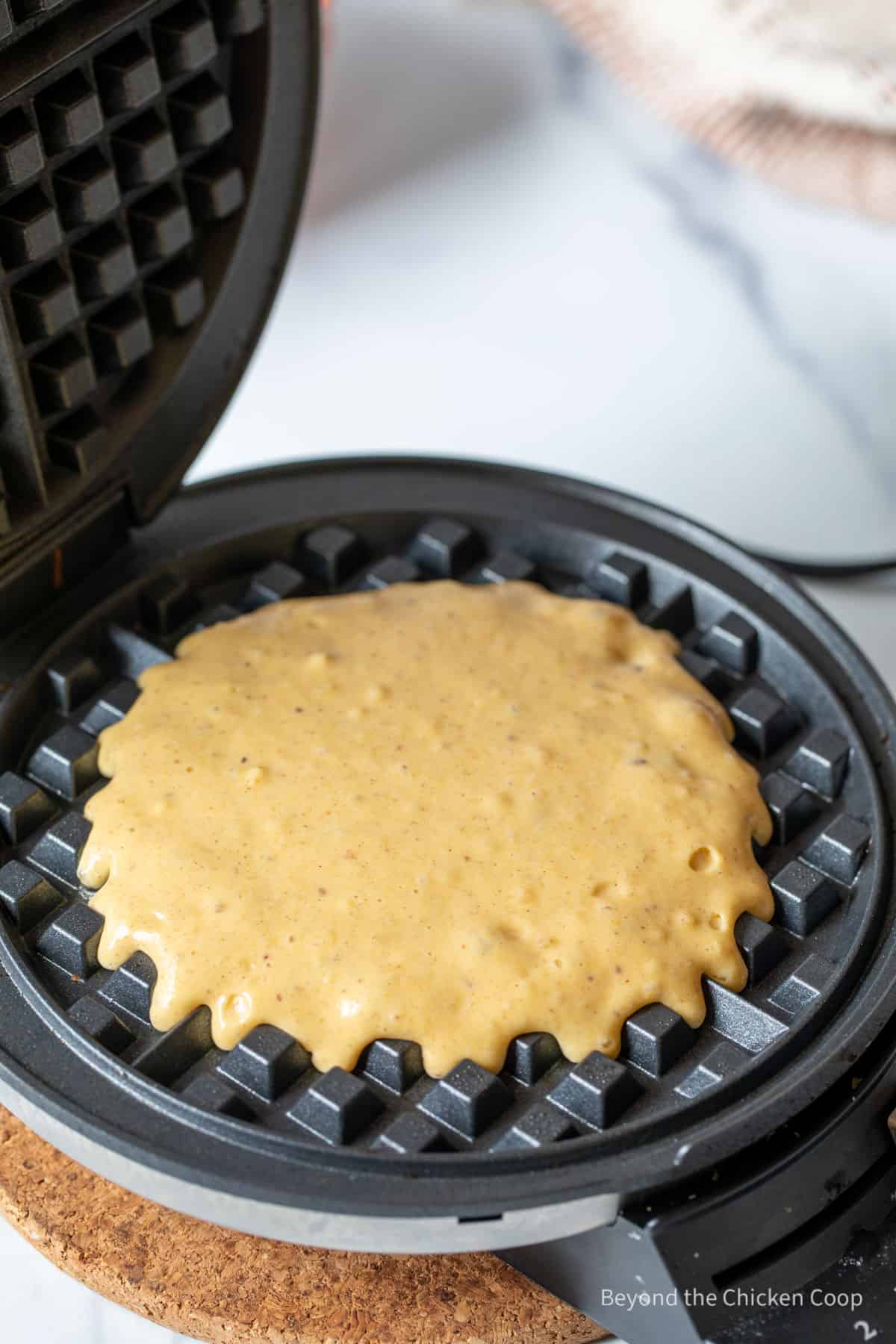 Pumpkin batter on a waffle iron.