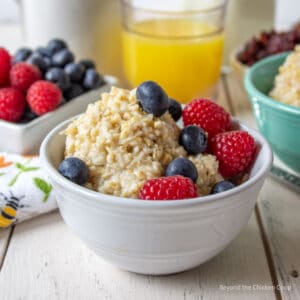 A bowl filled with oats and topped with fresh berries.