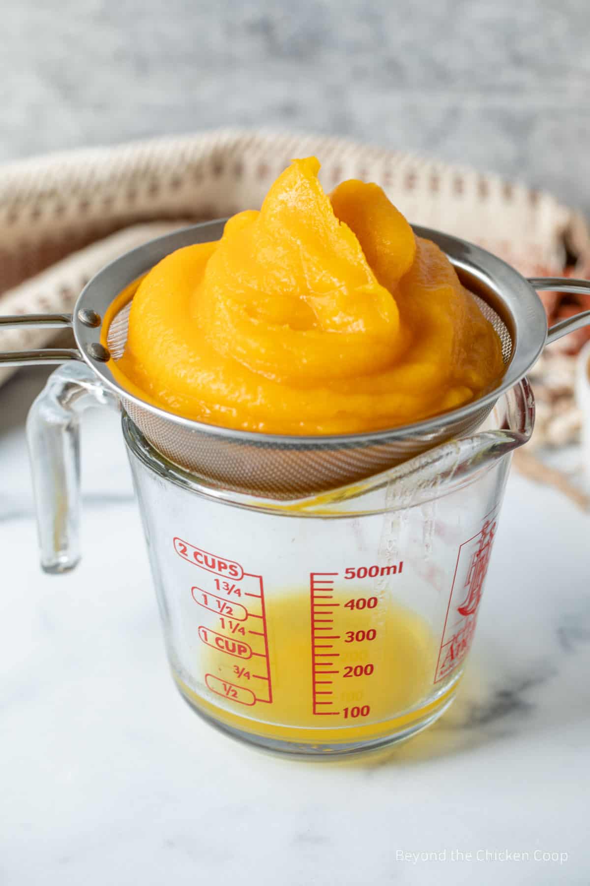 Draining the liquid from pumpkin puree.