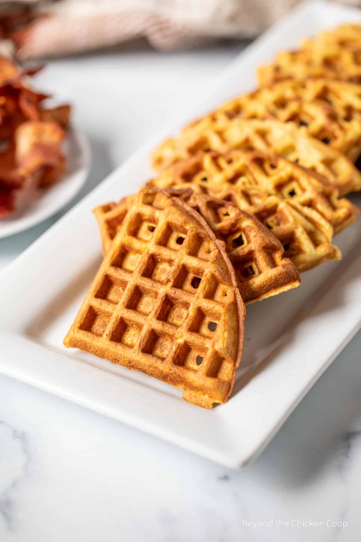 Platter filled with waffle wedges. 