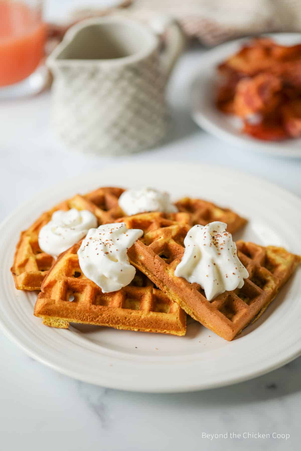Waffles topped with whipped cream.