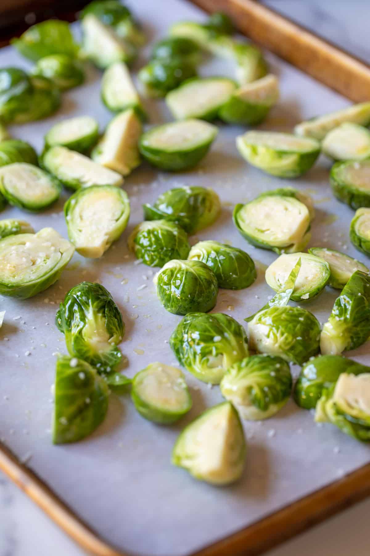 Halved brussels sprouts on a baking sheet. 