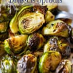 Brussels sprouts with a glaze on a white platter.