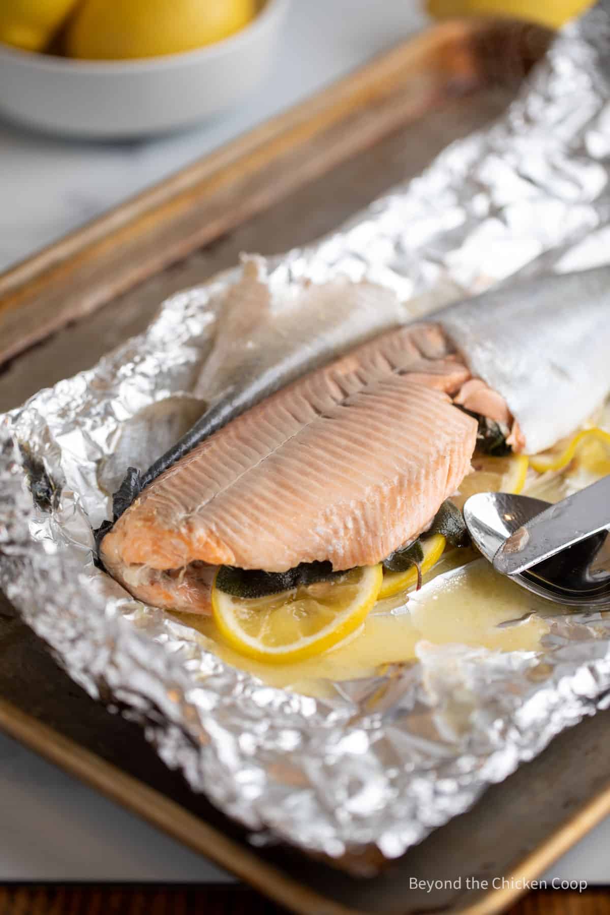 Removing the skin from baked trout. 