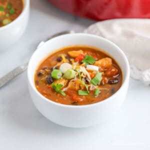 A white bowl filled with a black bean chili.