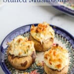 Three crab mushrooms on a blue and white plate.