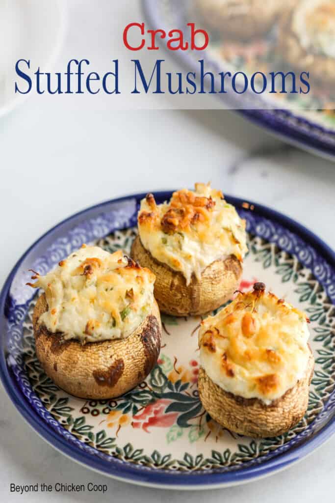Three crab mushrooms on a blue and white plate.