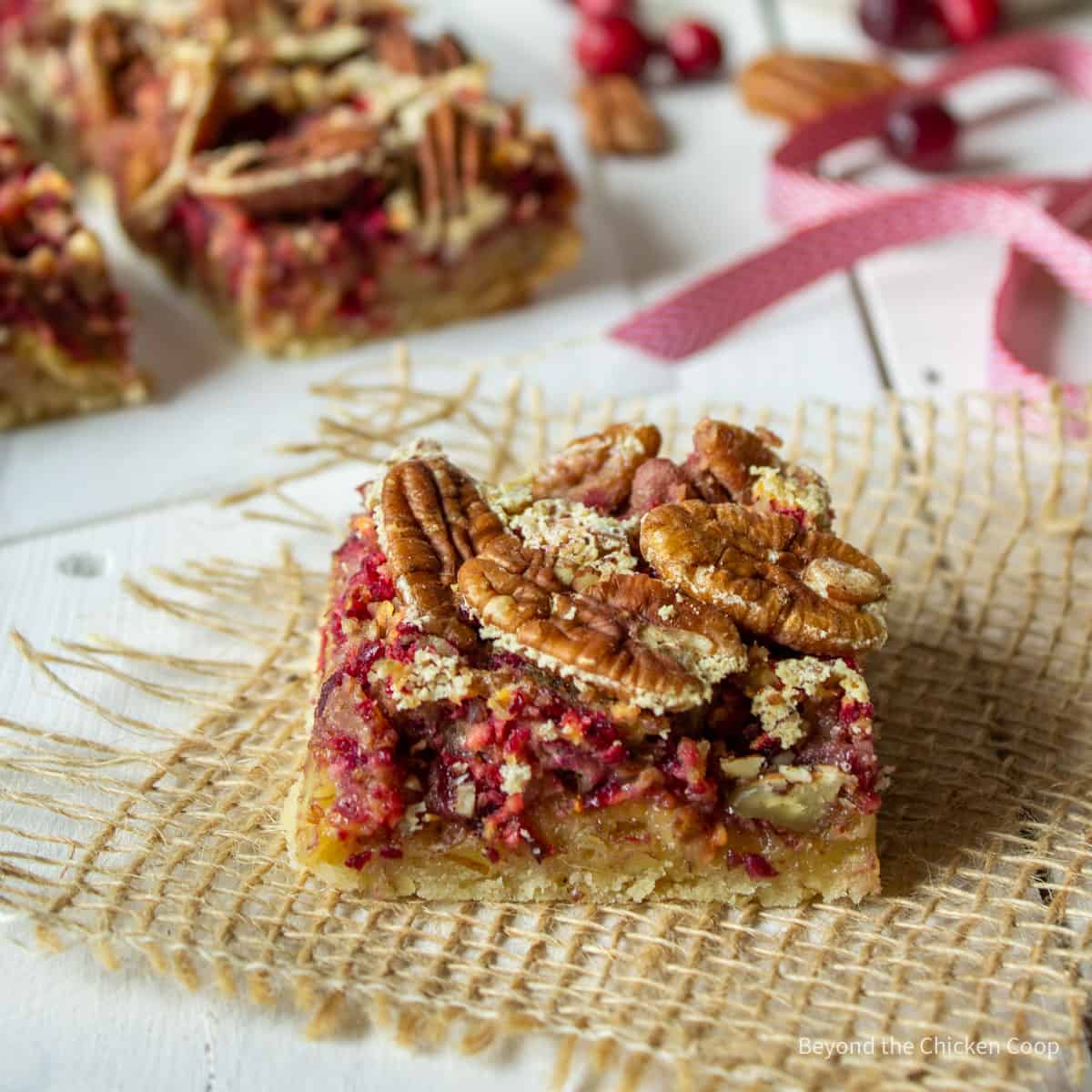 A cranberry bar topped with pecans.