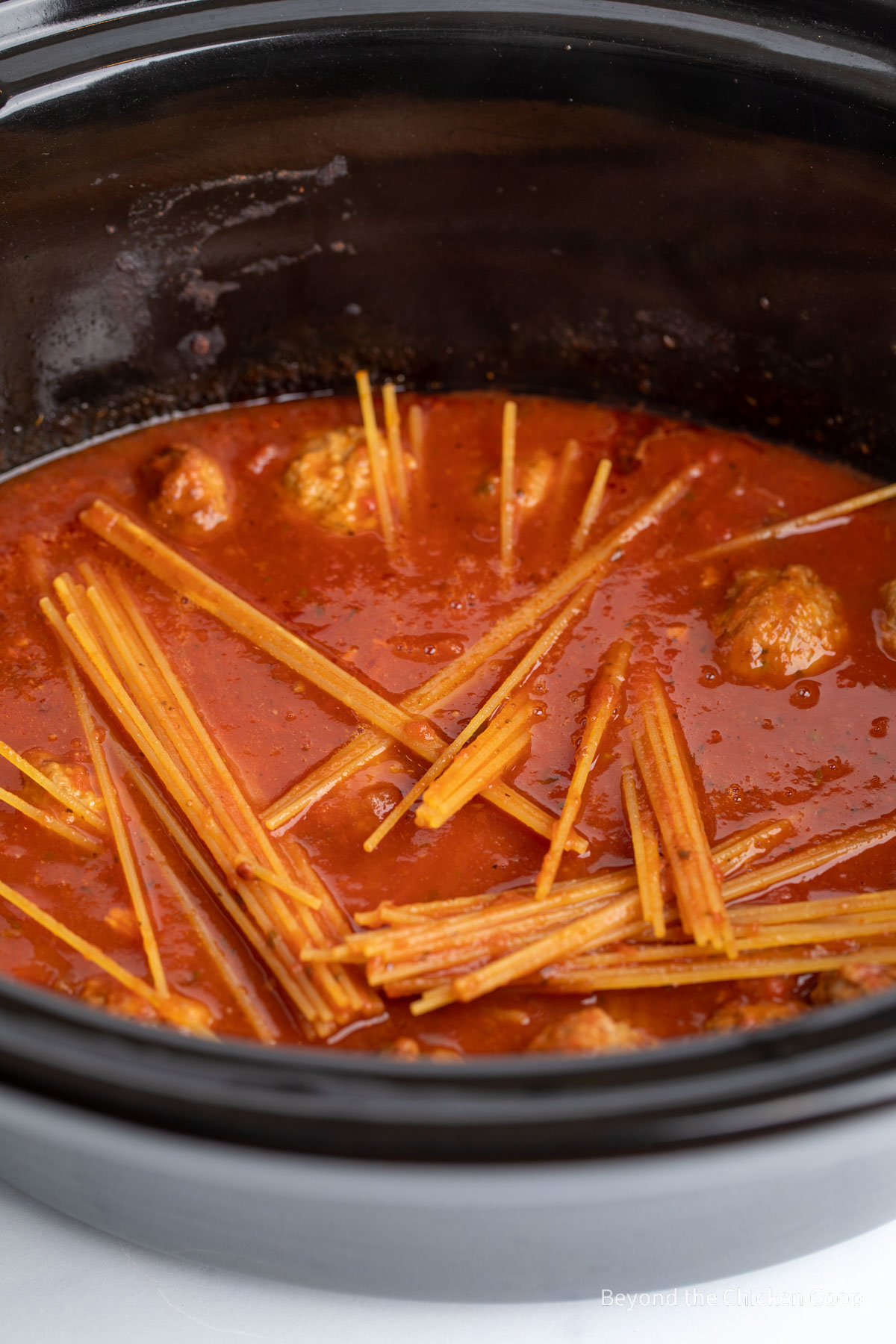 Uncooked spaghetti in a slow cooker. 