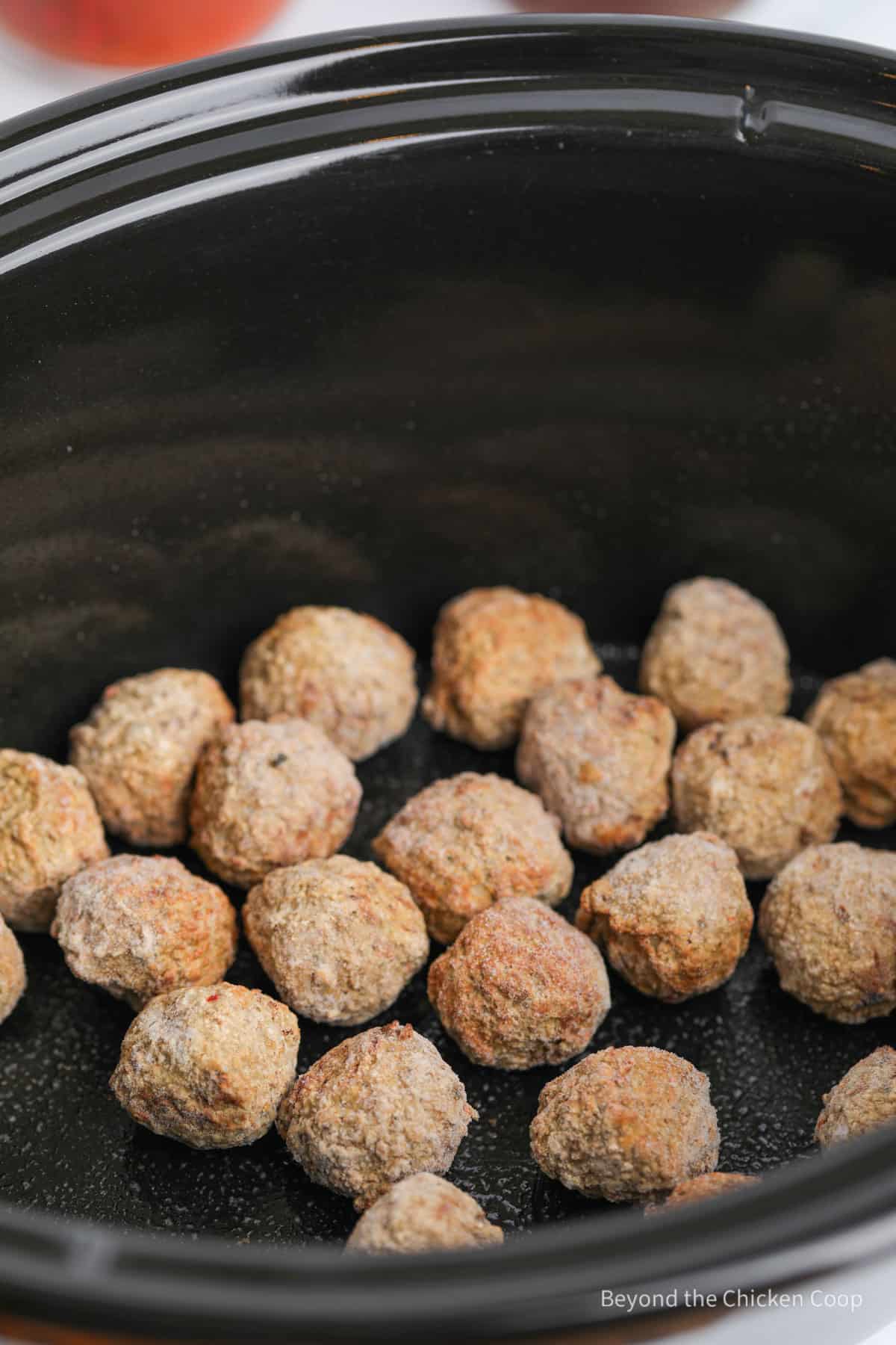 Frozen meatballs in the bottom of a crock pot. 