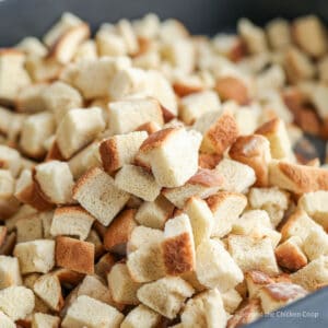 Dried bread cubes in a roasting pan.