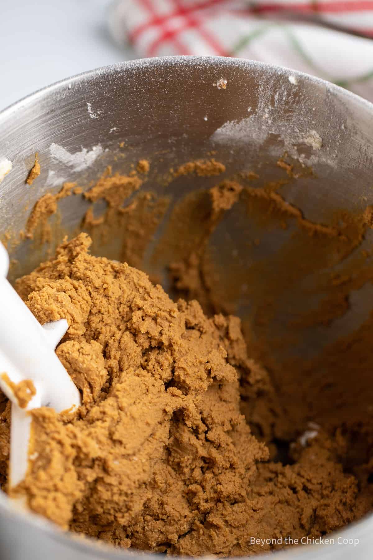 Mixing gingerbread dough in a mixing bowl. 