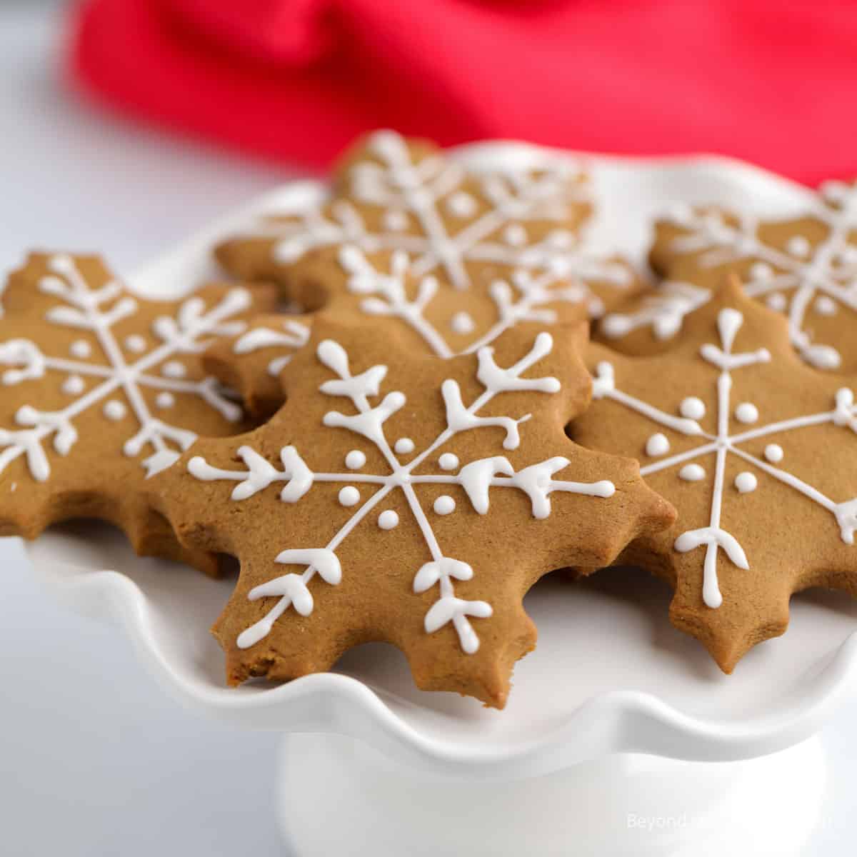 Gingerbread cookies with piped white frosting.