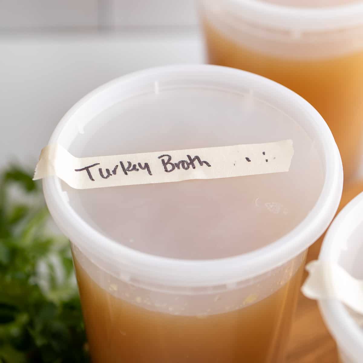 Plastic containers filled with turkey broth.