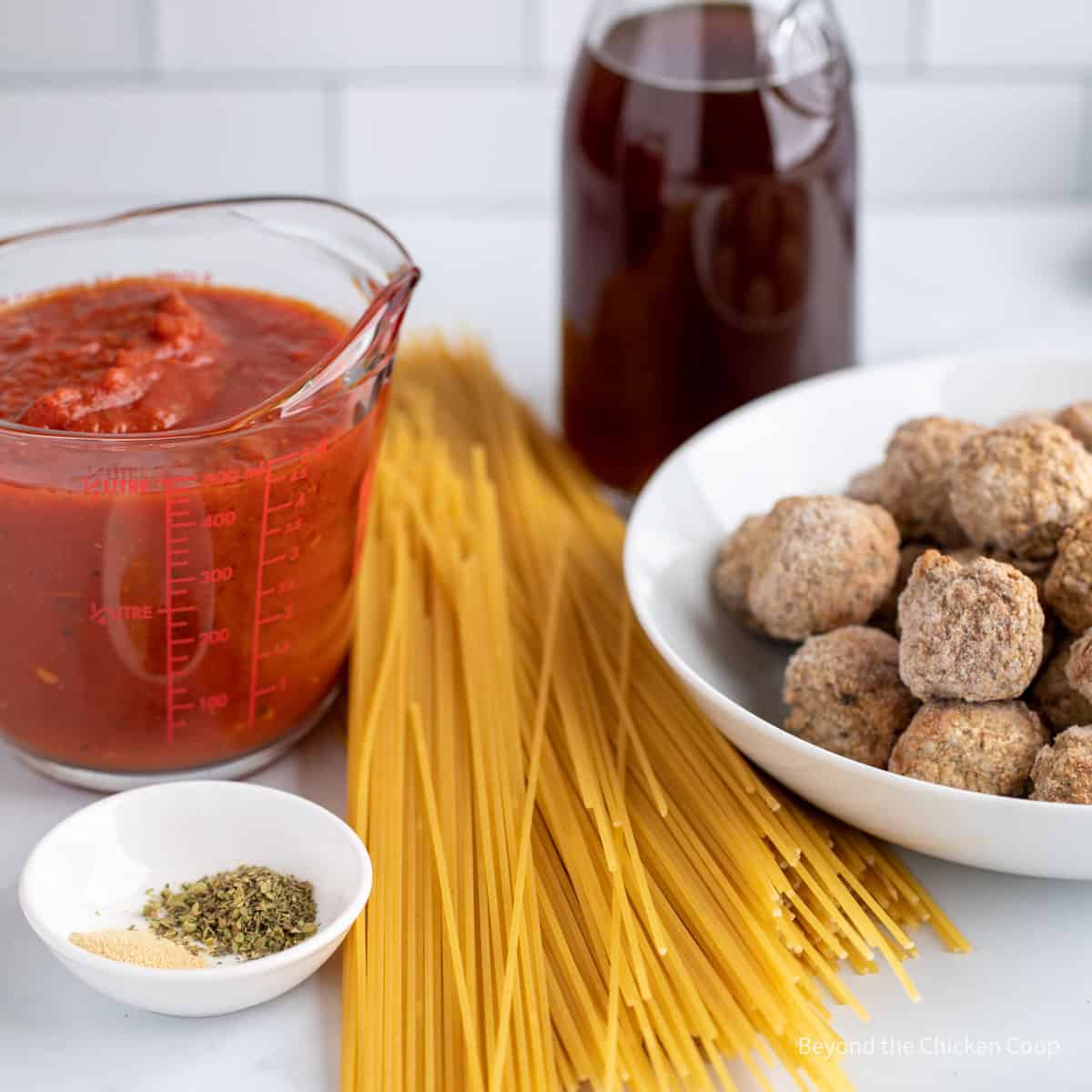 Uncooked pasta, frozen meatballs and tomato sauce.