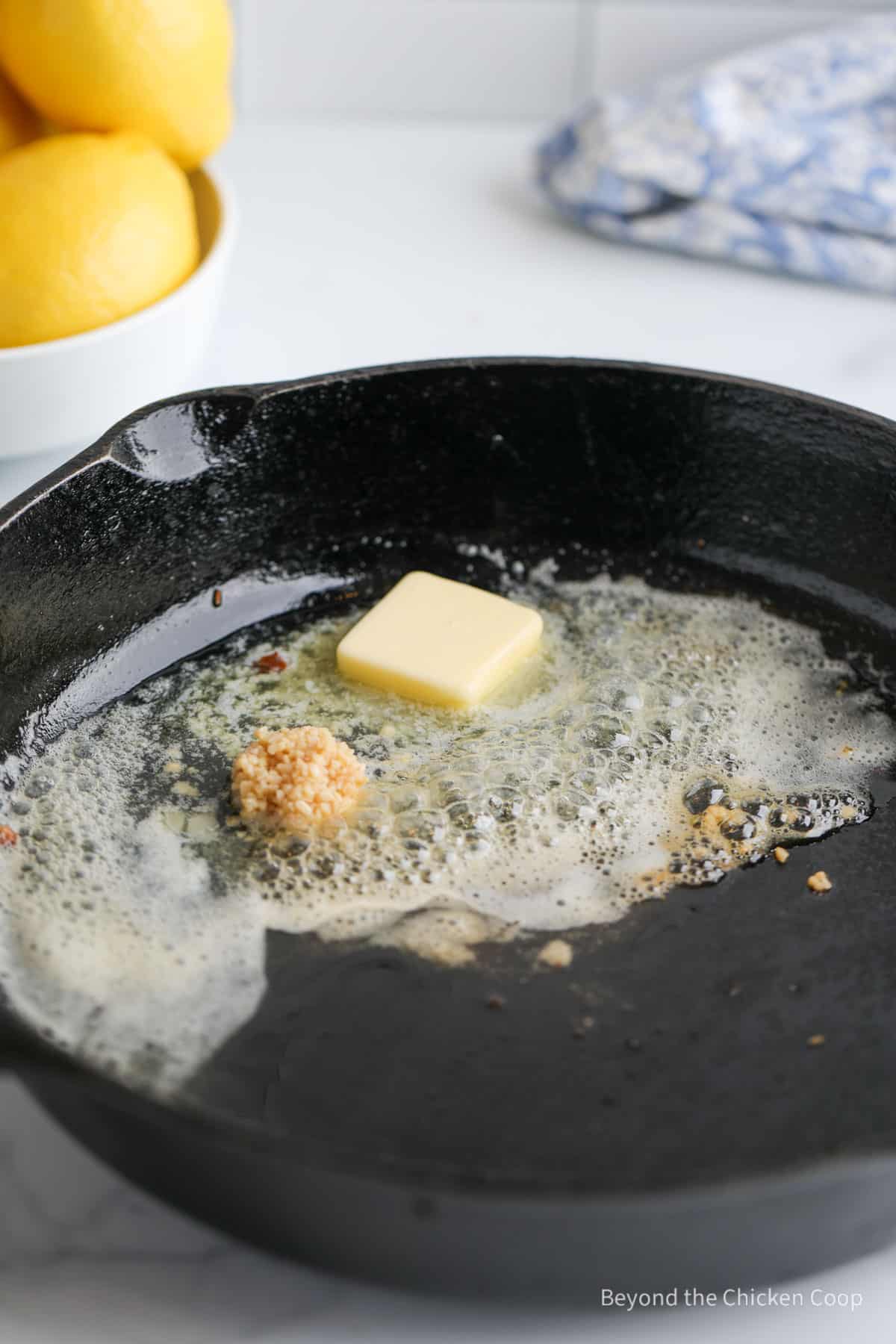 Butter, garlic and capers in a pan. 