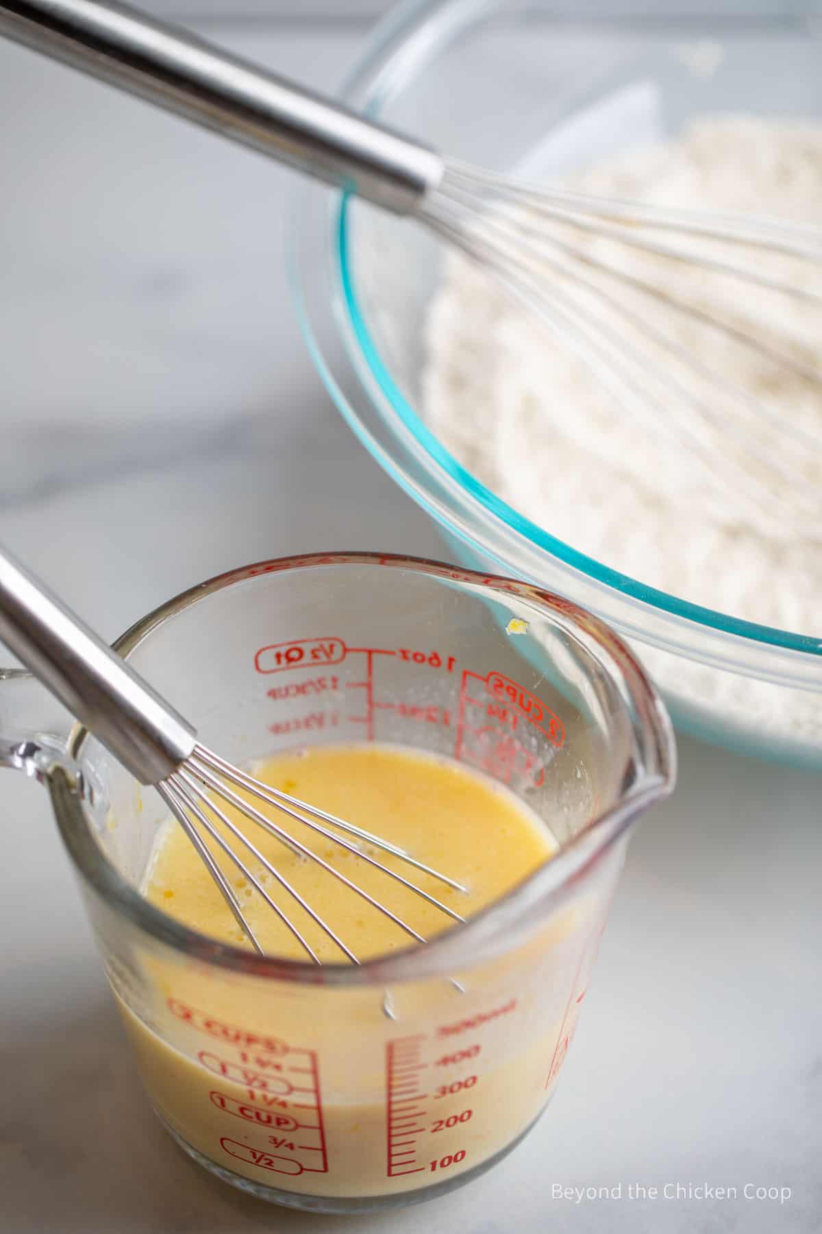 Two bowls with dry ingredients and wet ingredients.