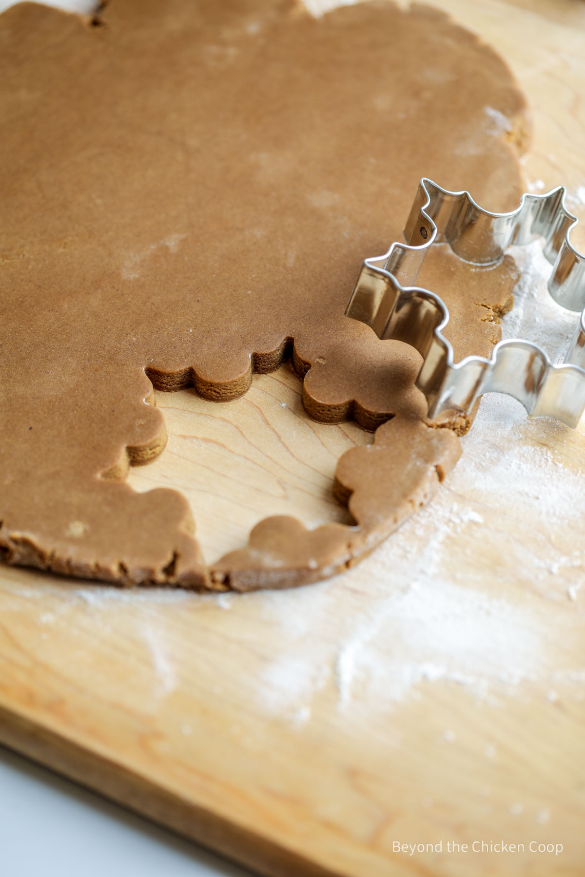 Cutting out snowflake shaped cookies. 