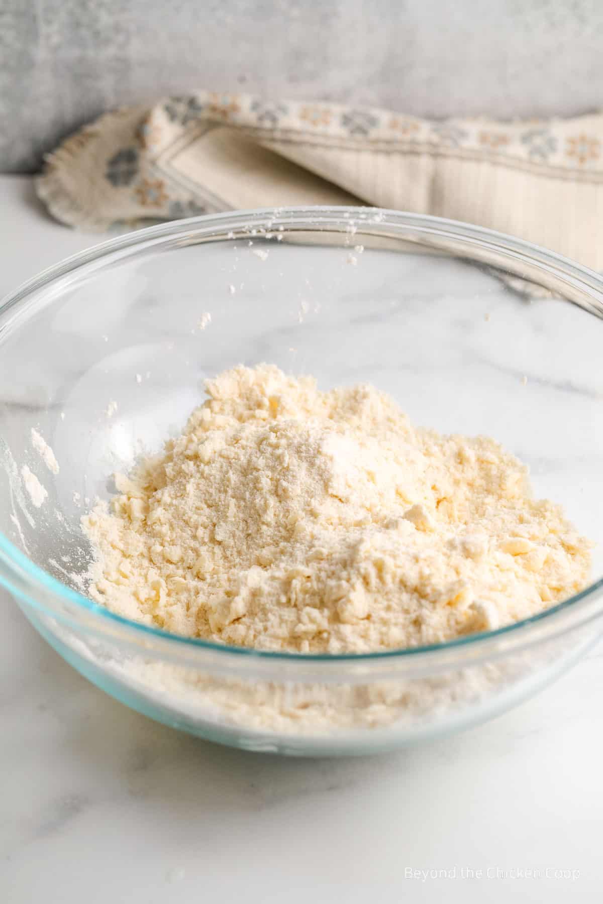 Mixed shortbread dough in a glass bowl.