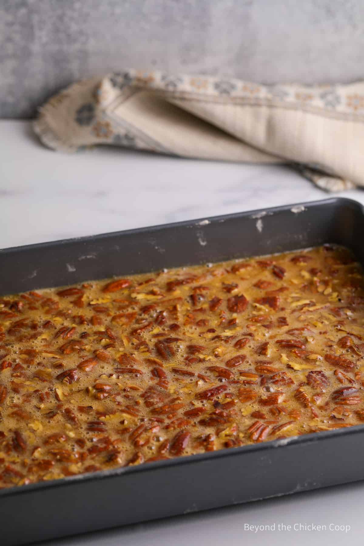 Unbaked pie bars in a metal baking pan.