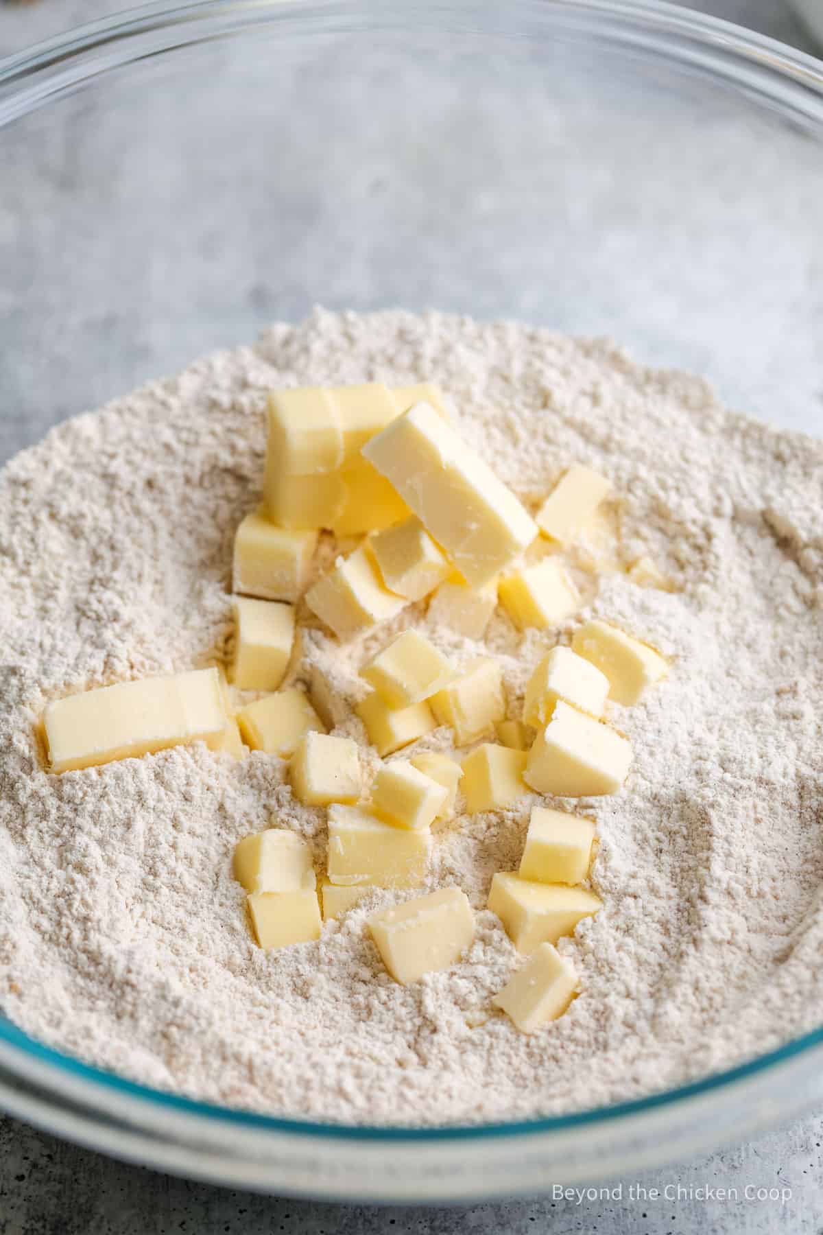 Adding butter to flour.