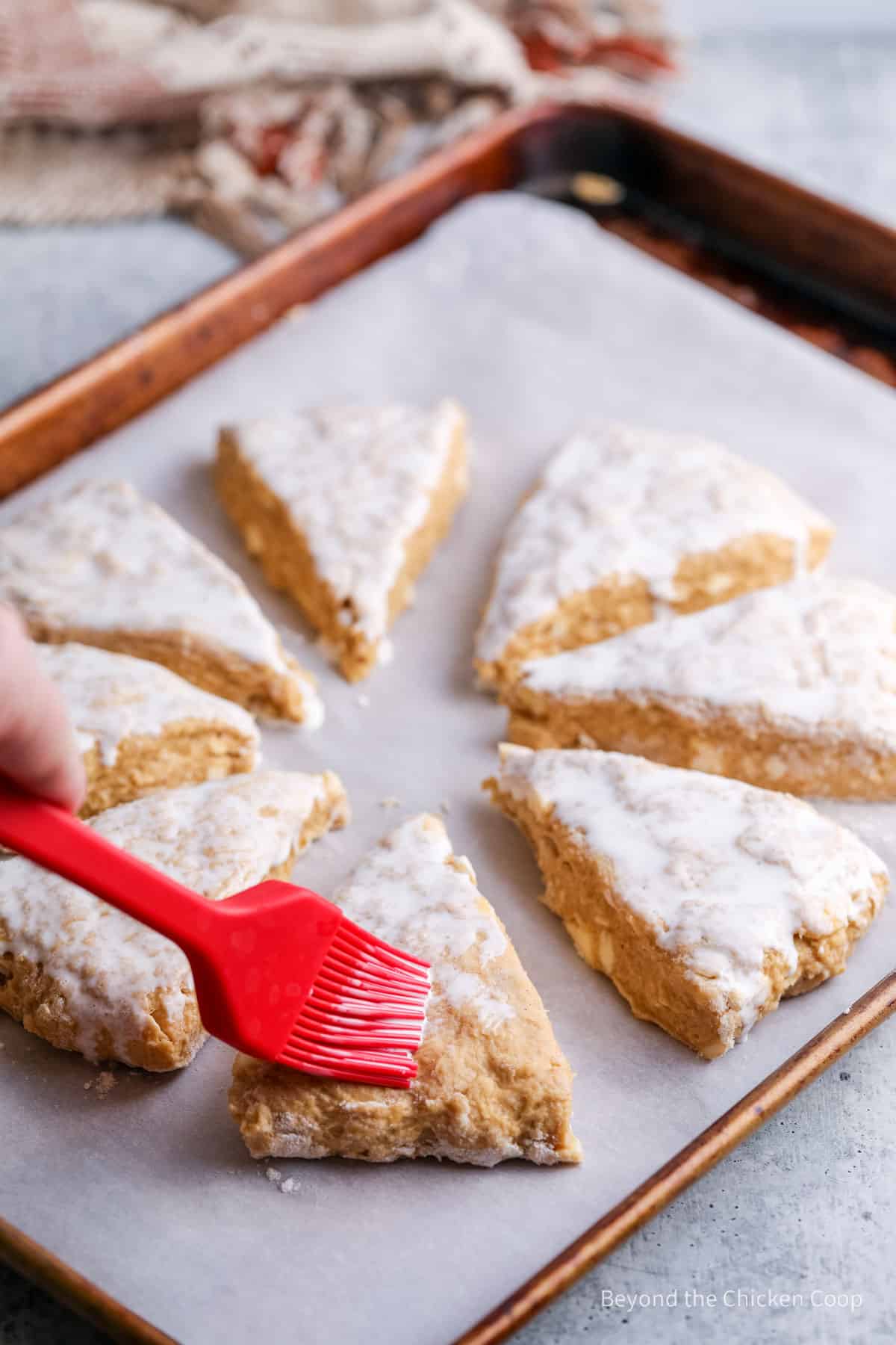 Unbaked scones basted with cream.