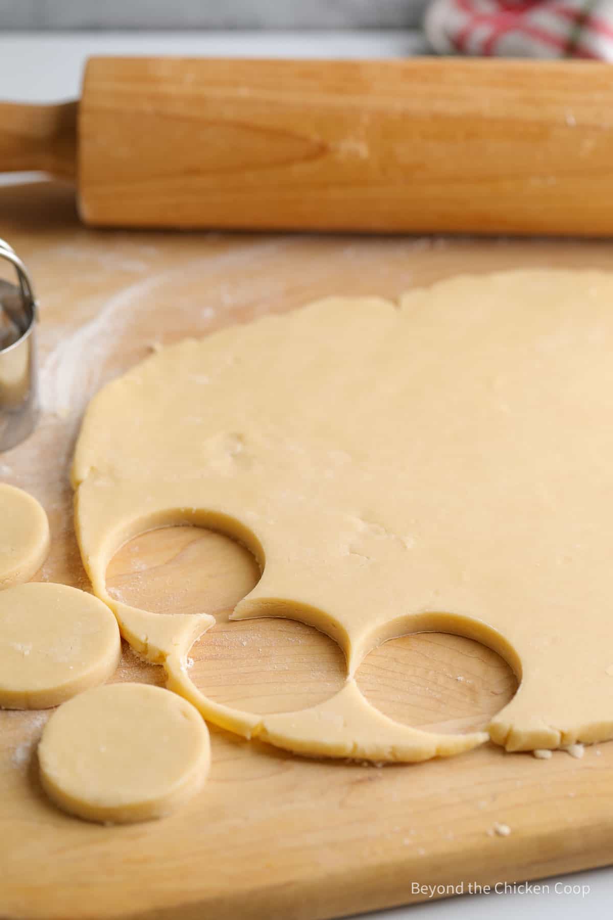 Cutting out round circles from cookie dough. 