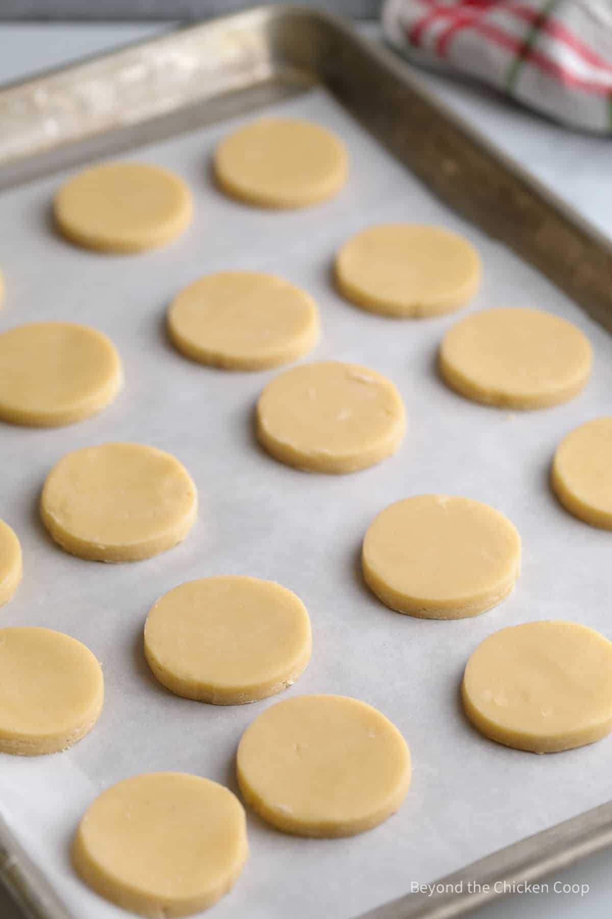 Round unbaked cookies on a baking sheet. 