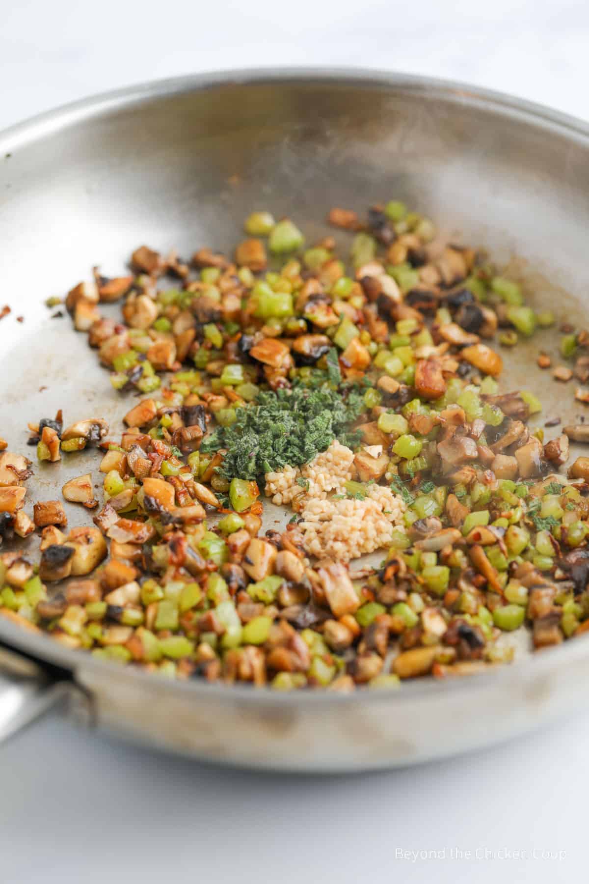 Vegetables in a pan with garlic and fresh herbs. 