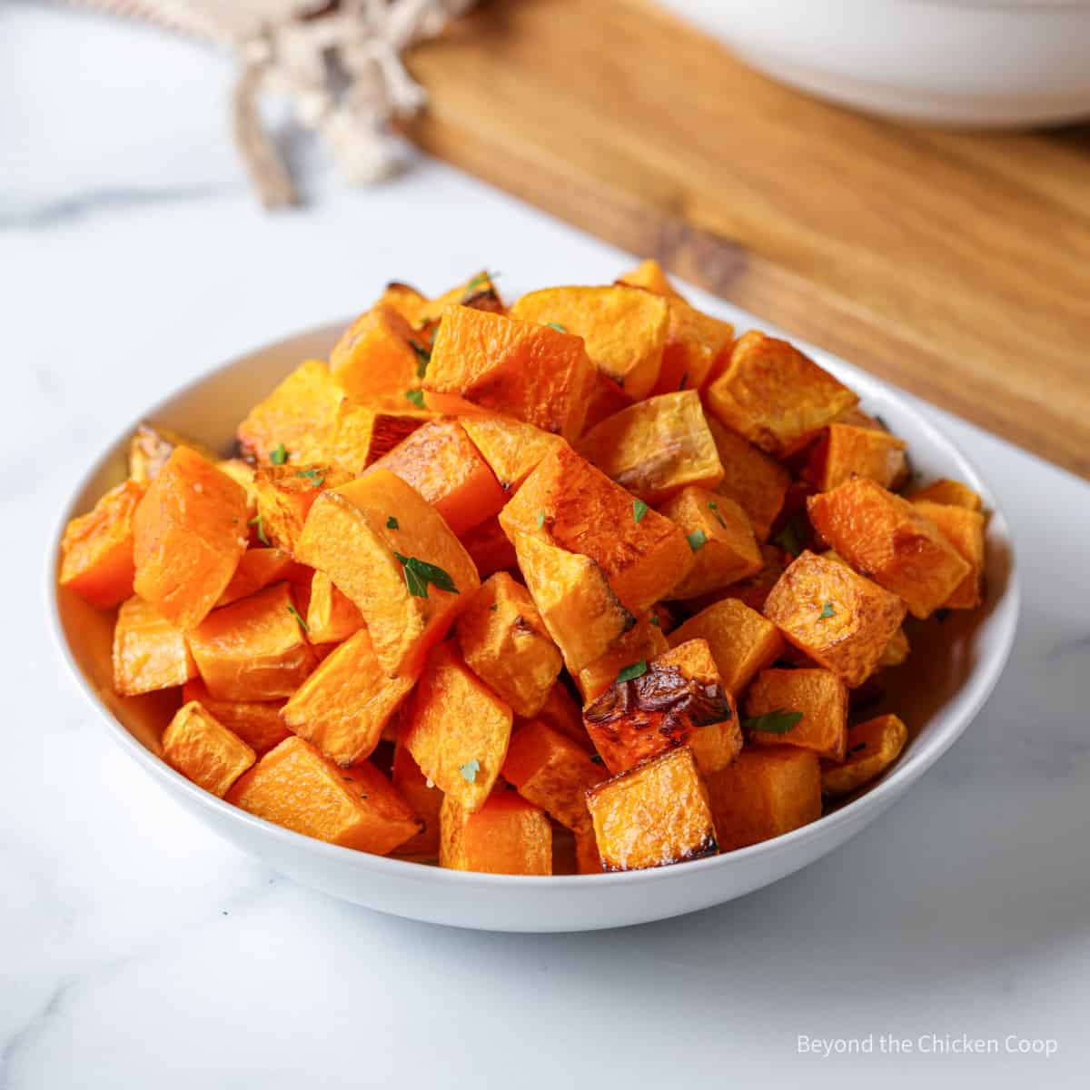 A bowl filled with cooked butternut squash.